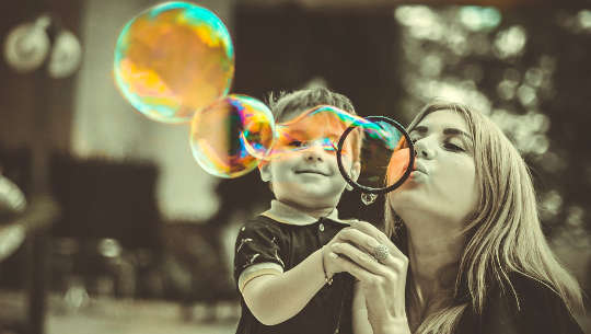 mother and child blowing bubbles