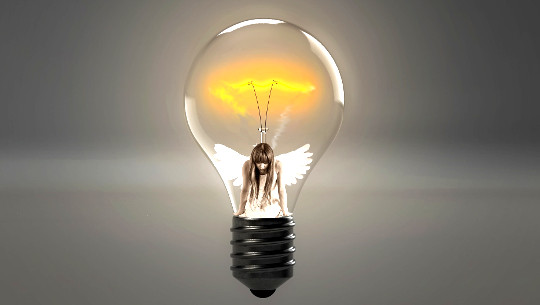 girl with angel wings inside a light bulb