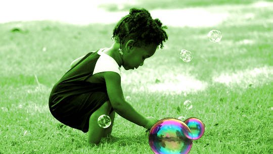 child playing with bubbles