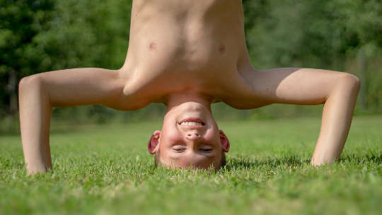 young boy doing a headstand