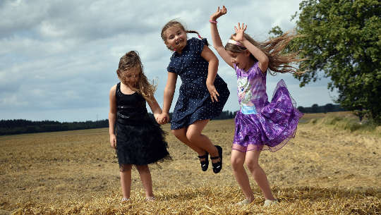 young girls jumping for joy